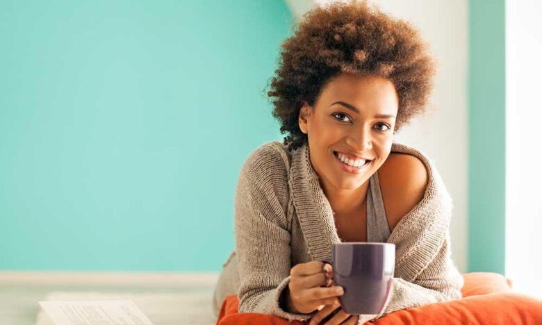 A woman holds a coffee mug as she learns about the latest IVF protocols